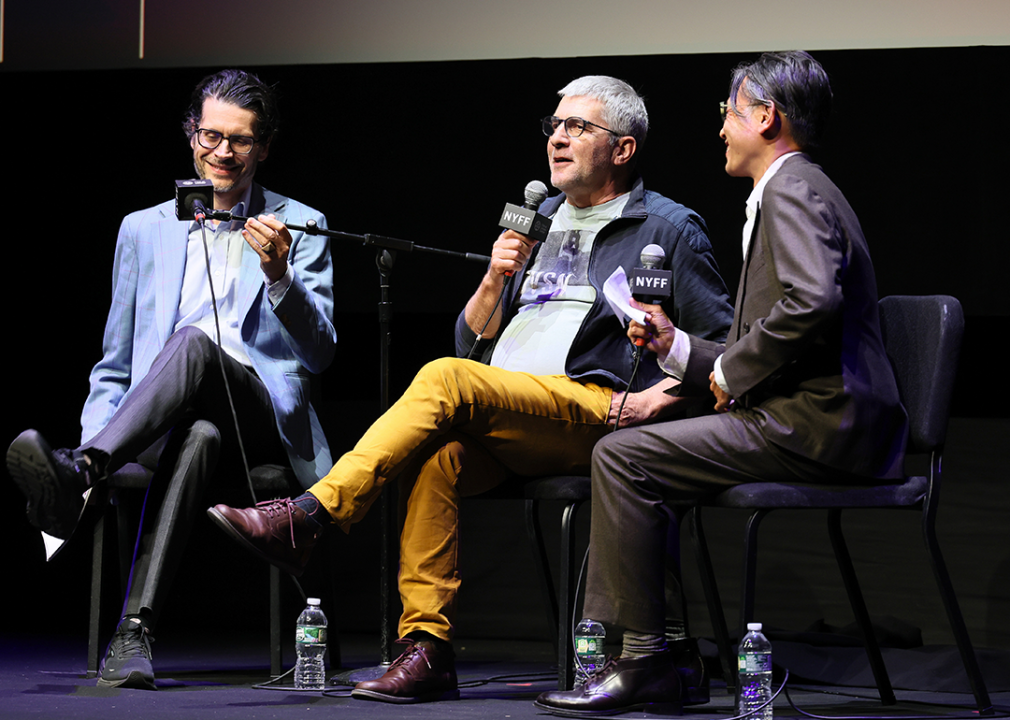 Nicholas Elliott, Alain Guiraudie, and Dennis Lim speak on stage at the New York Film Festival.